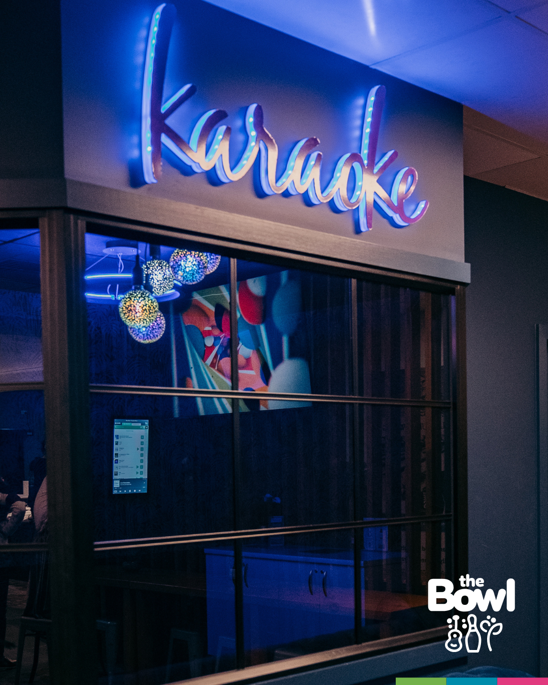 A pink neon Karaoke sign above the glass-fronted private karaoke room at The Bowl in Port Macquarie